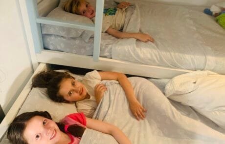 Carolina e i suoi fratelli, all'ora di andare a letto, sui letti a castello della loro camera.